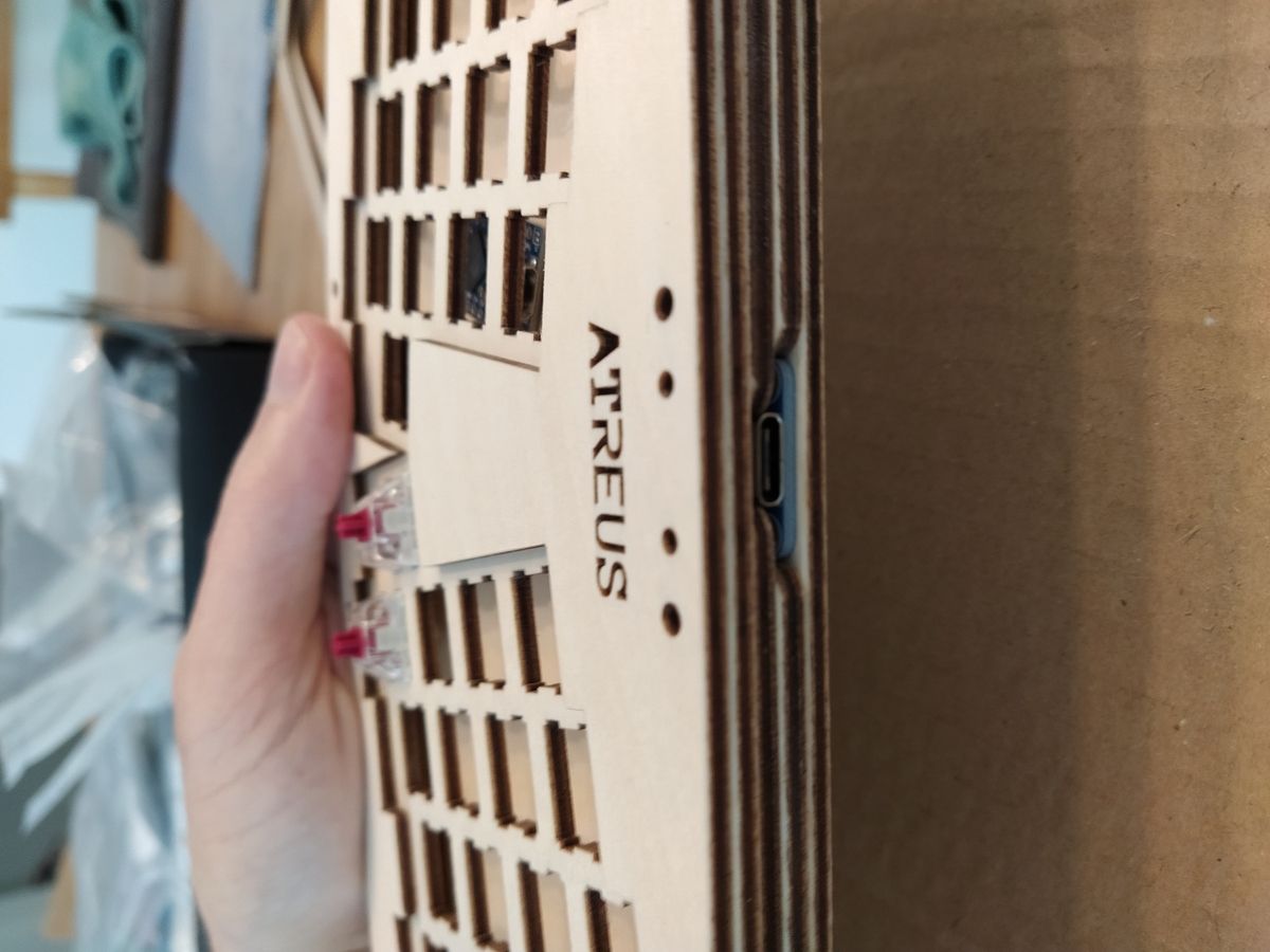Wooden spacer with a rectangular cutout housing a USB-C breakout board and cable, showing the custom modification for USB-C connectivity.
