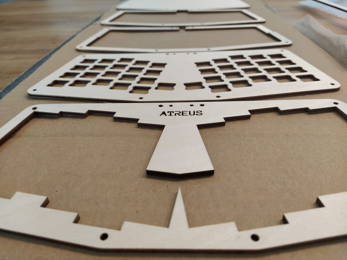 Edge-on view of stacked plywood layers showing the sandwiched construction of the keyboard case with visible wood grain.