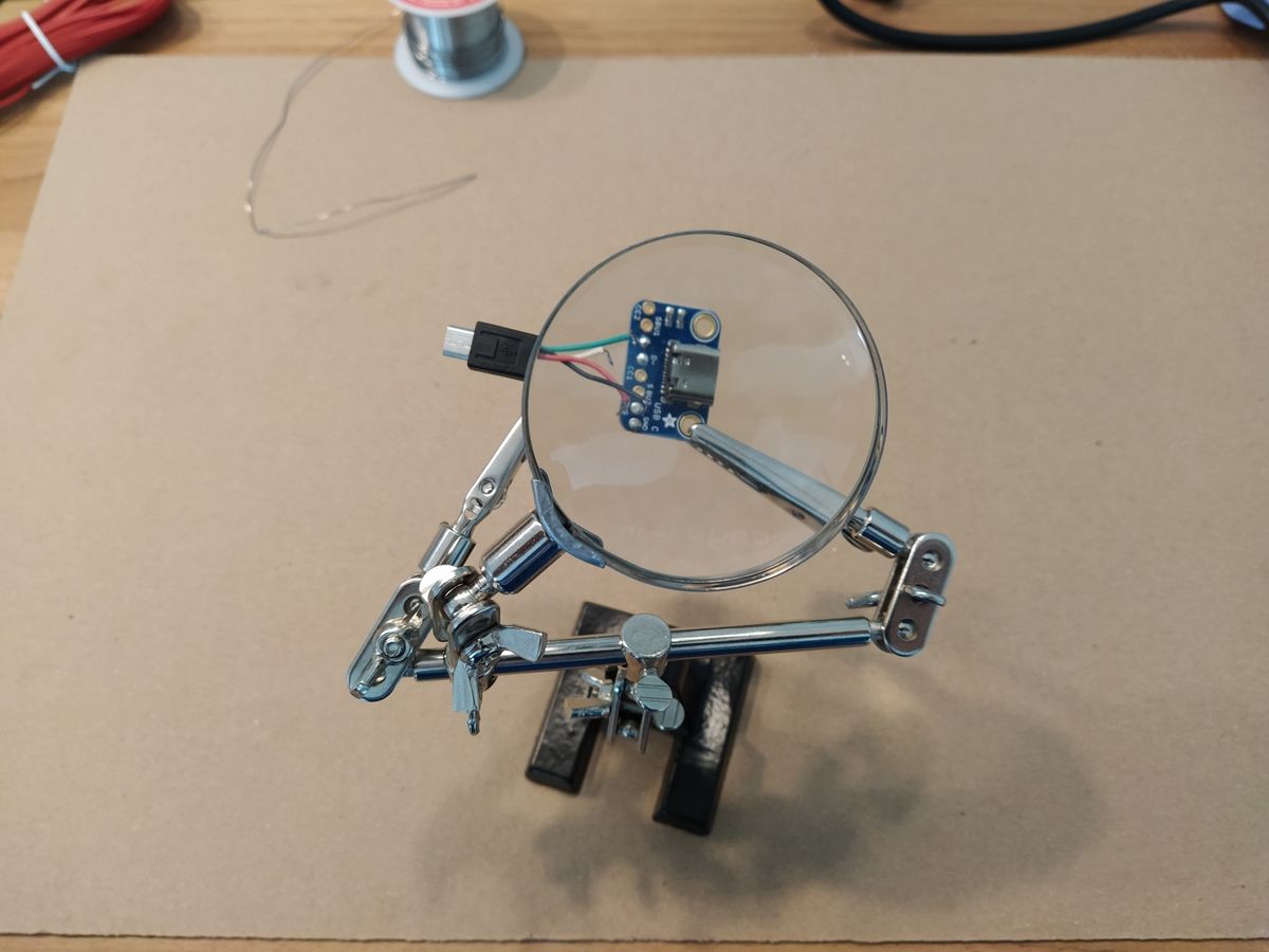 Thin colored wires (red, black, green, white) soldered to a small circuit board