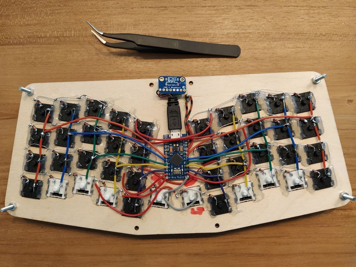 Two header pins soldered to RST and GND pins on Pro Micro microcontroller board