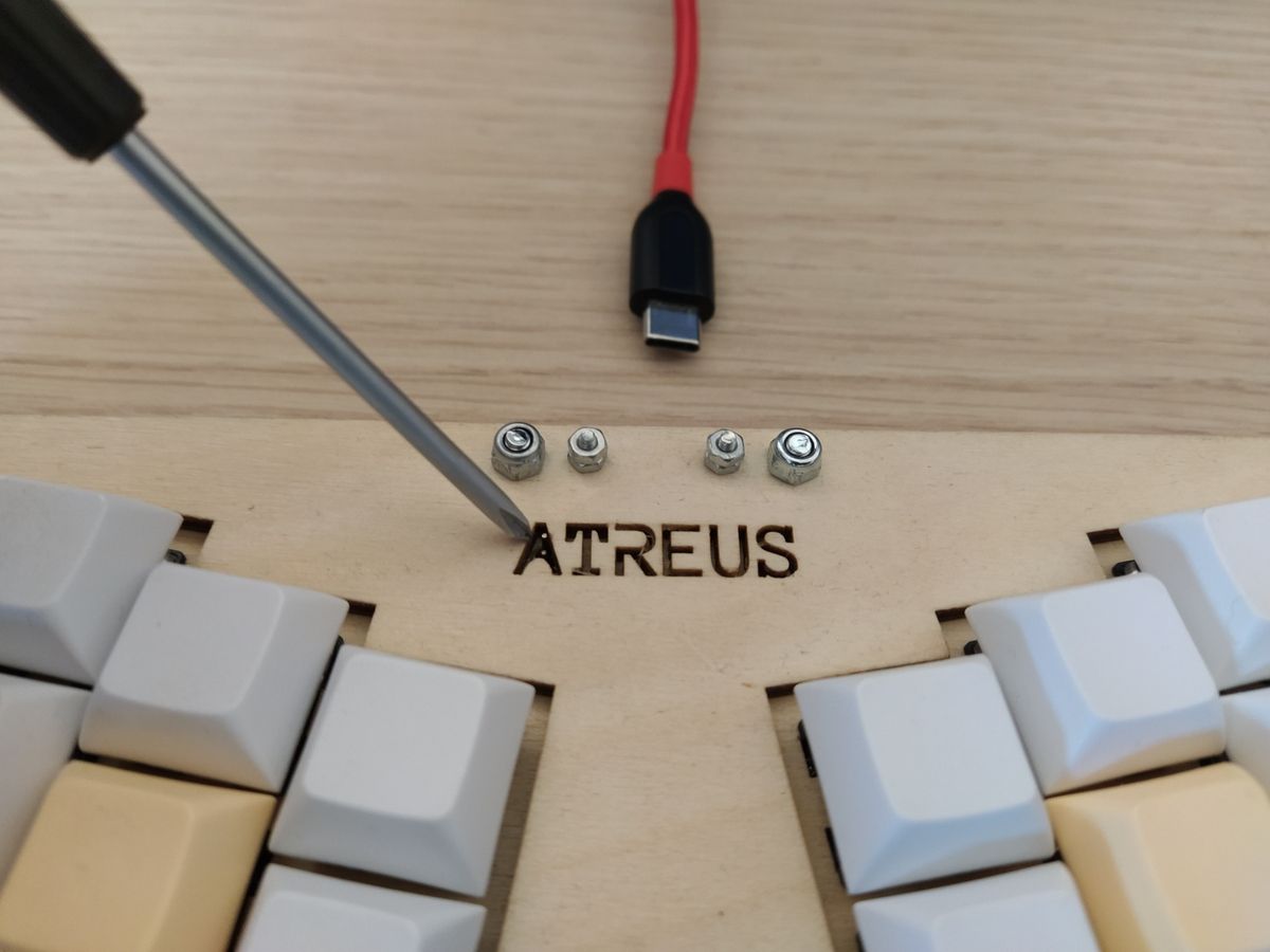Two reset pin headers protruding through case hole for shorting with a screwdriver