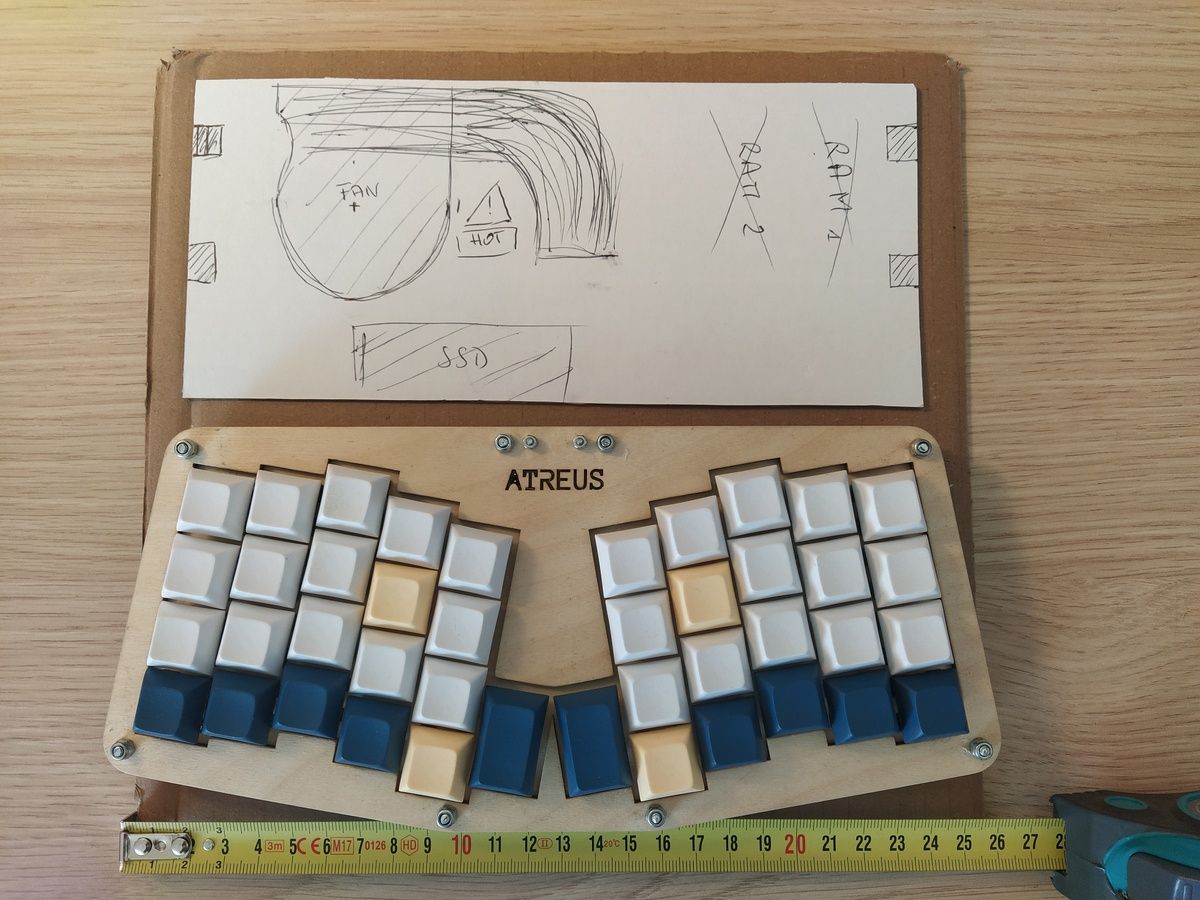 A sheet of cardboard with a hand-drawn Framework Mainboard at the top, and an Atreus keyboard at the bottom.